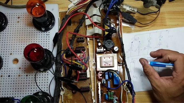 Kỹ thuật viên đang kiểm tra và sửa chữa bo mạch máy giặt